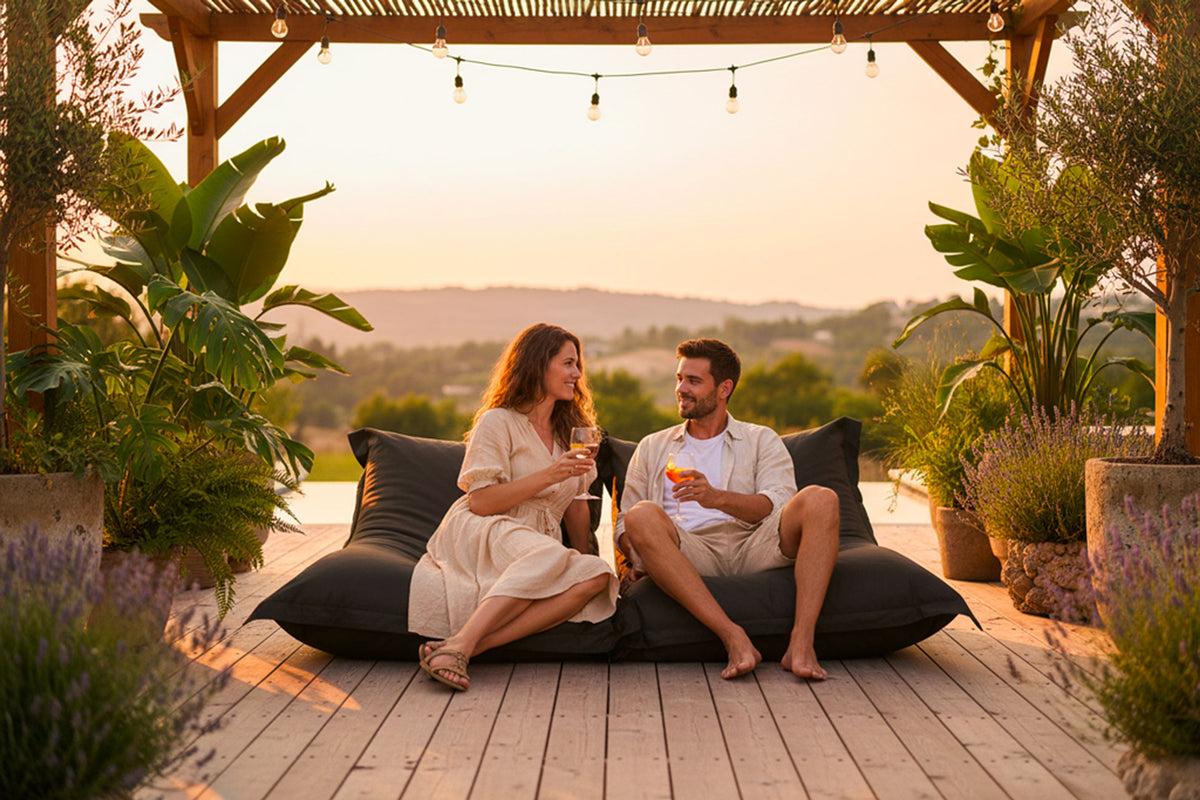 Pouf Extérieur Noir IRON RAW XXL 170 x 130 cm, coin détente extérieur avec deux personnes sur terrasse