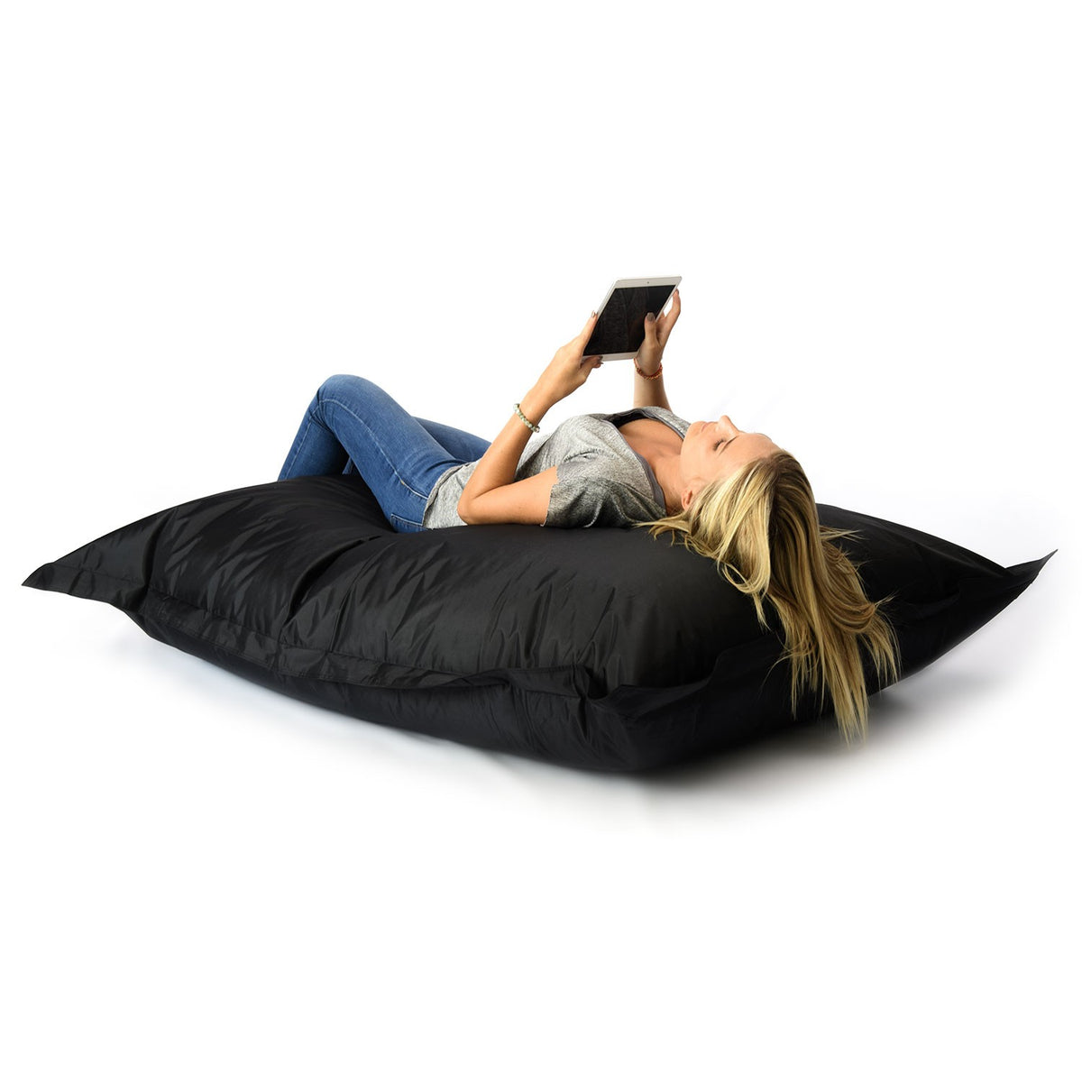 Pouf Géant XL Noir : femme allongée sur un pouf grand format noir pour salon, chambre ou jardin