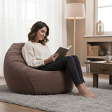 Pouf Poire Velours Côtelé Marron : assise confortable en velours côtelé, style poire marron pour salon, femme lisant