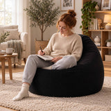 Pouf Poire Velours Côtelé Noir en velours côtelé noir, assise confortable dans un salon lumineux